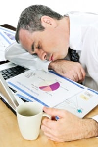 Businessman asleep at his desk - side-effects of sleep medication?