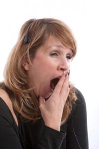 Woman yawning very wide - perhaps she is suffering from a sleep disorder?